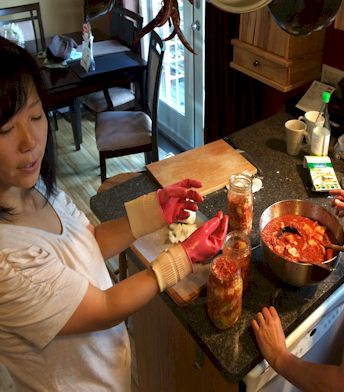 Sauce Spreading and pressing down into jars